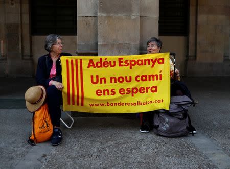 Demonstrators hold up a banner reading "Goodbye Spain, A new path awaits us" near the Catalan regional parliament in Barcelona, Spain, October 27, 2017. REUTERS/Juan Medina