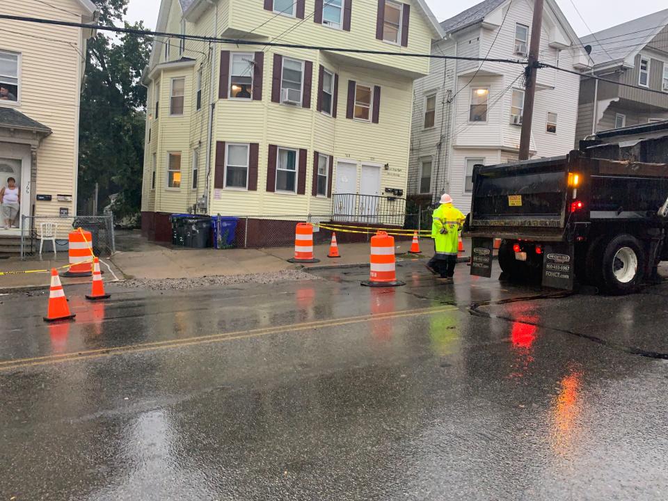 Providence workers repair a drain on Atwells Avenue on Monday.