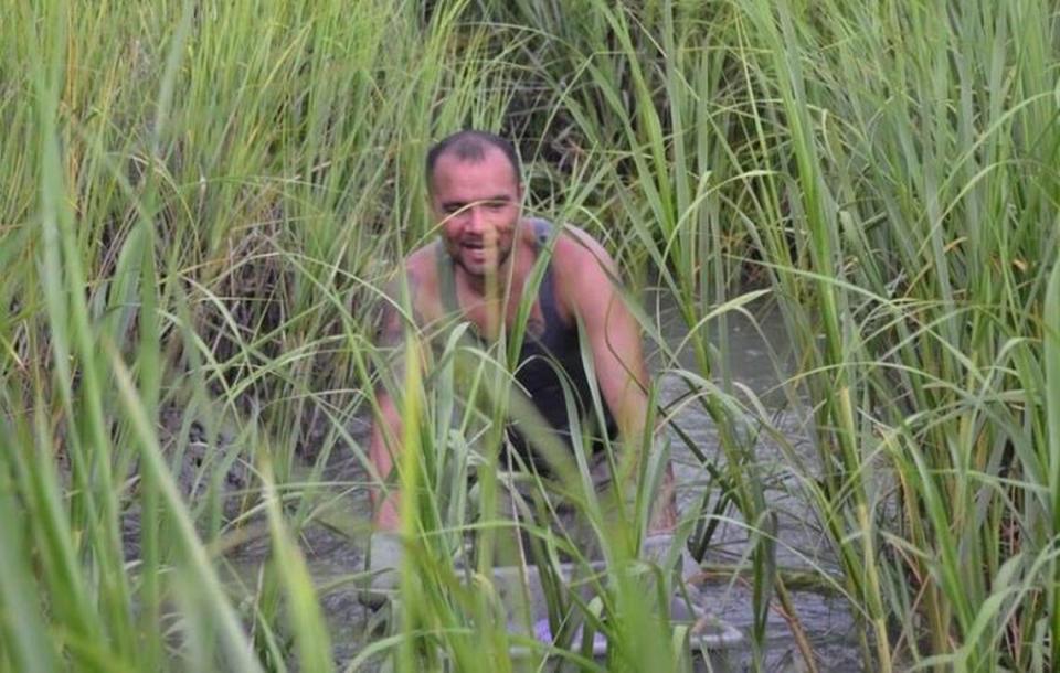 Daniel Cardenas-Andrade wades in Broad Creek waters on a clamming excursion with crews from the Sea Eagle Market in Beaufort. The 52-year-old was killed in late February in a single-car accident outside Yemassee. Courtesy of Craig Reaves