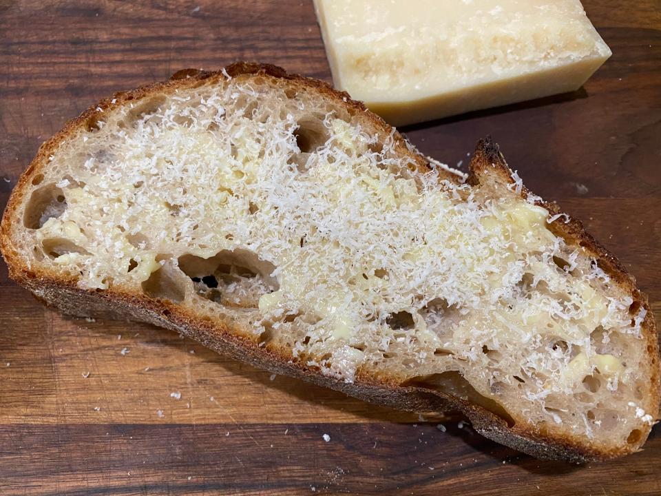 Parmesan cheese on a slide of buttered bread