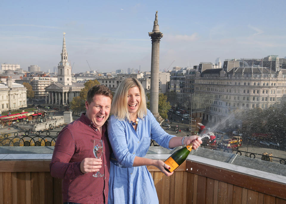 Gavin and Sylvia Odolant-Smith, celebrate their lottery win by spraying a bottle of champagne.