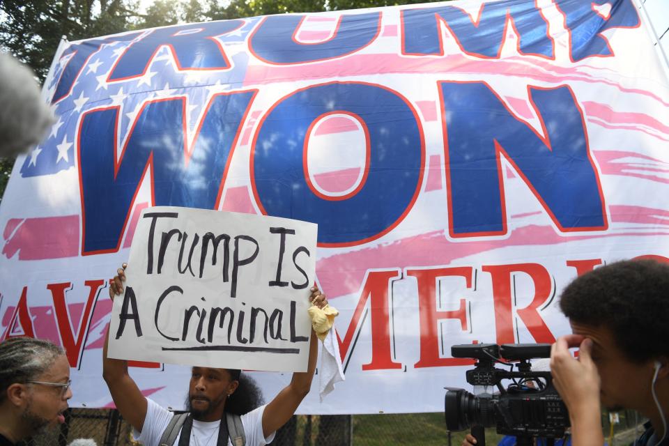 Protesters stand outside the at Fulton County Jail intake center in Atlanta, GA. on Aug 24, 2023, waiting for the arrival of former President Donald Trump.