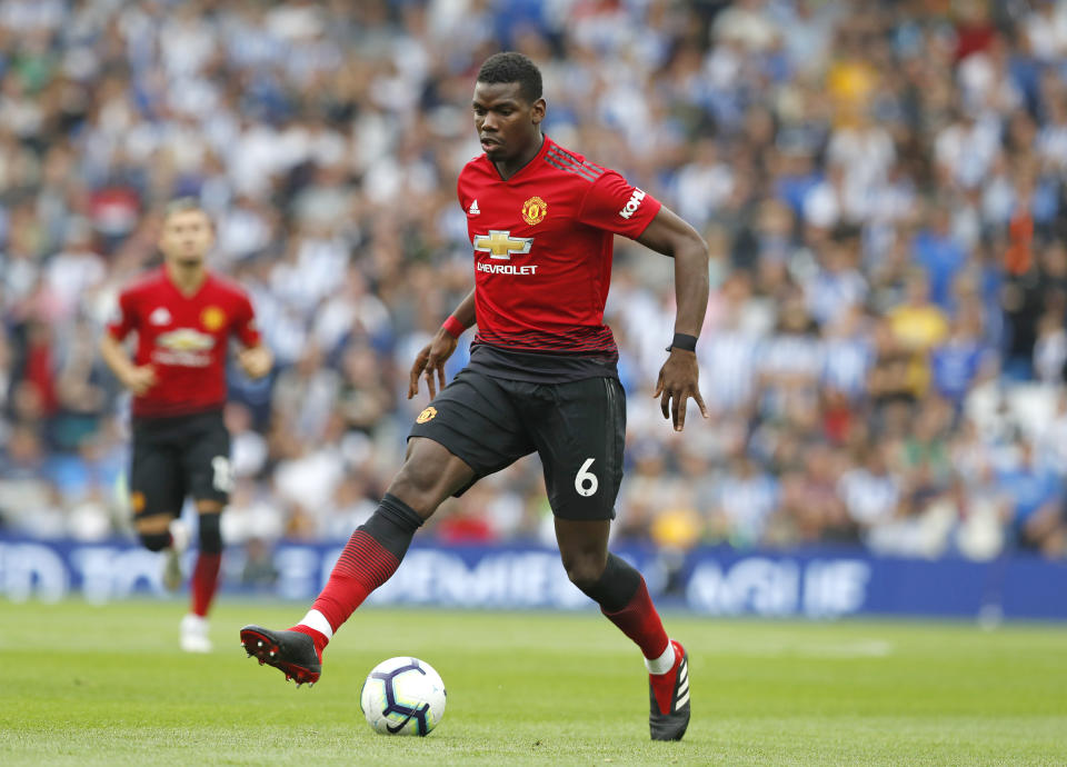 Manchester United's Paul Pogba runs with the ball during the English Premier League soccer match between Brighton and Hove Albion and Manchester United at the Amex stadium in Brighton, England, Sunday, Aug.19, 2018. (AP Photo/Alastair Grant)