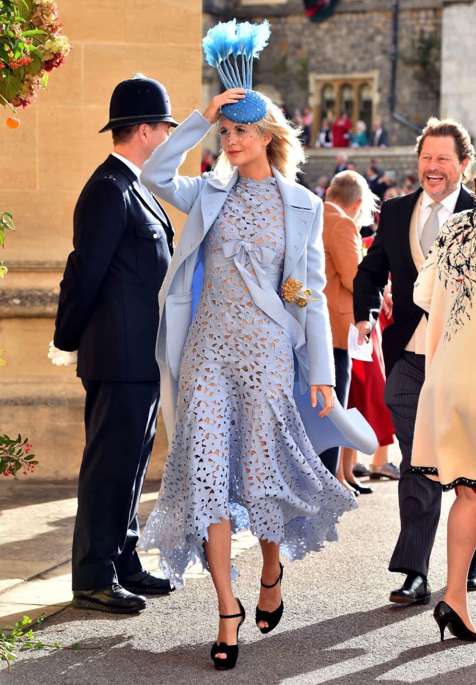 <p>Poppy Delevingne's pastel blue coat and lace dress combo complimented her blonde hair and bright red lip perfectly on Princess Eugenie and Jack Brooksbank's wedding day. </p>