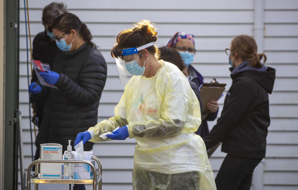 A nurse prepares to test people at a COVID-19 testing station in Wellington, New Zealand, Thursday, June 24, 2021. After enjoying nearly four months without any community transmission of the coronavirus, New Zealanders were on edge Wednesday after health authorities said an infectious traveler from Australia had visited over the weekend. (Mark Mitchell/NZ Herald via AP)