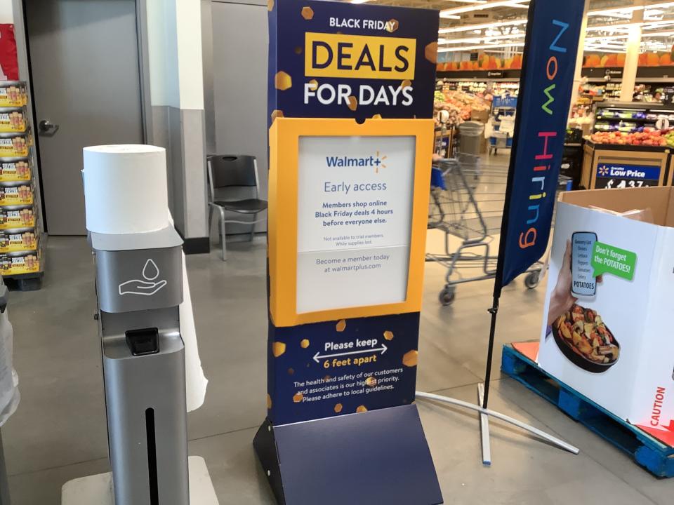 Interior signage at a Walmart supercenter promotes the store's Black Friday shopping deals.