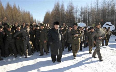 vNorth Korean leader Kim Jong Un (C) visits the 991 Unit of the Korean People's Army (KPA) Air and Anti-Air Force to congratulate personnel there on the Day of Airmen this undated photo released by North Korea's Korean Central News Agency (KCNA) in Pyongyang November 30, 2013. REUTERS/KCNA/Files