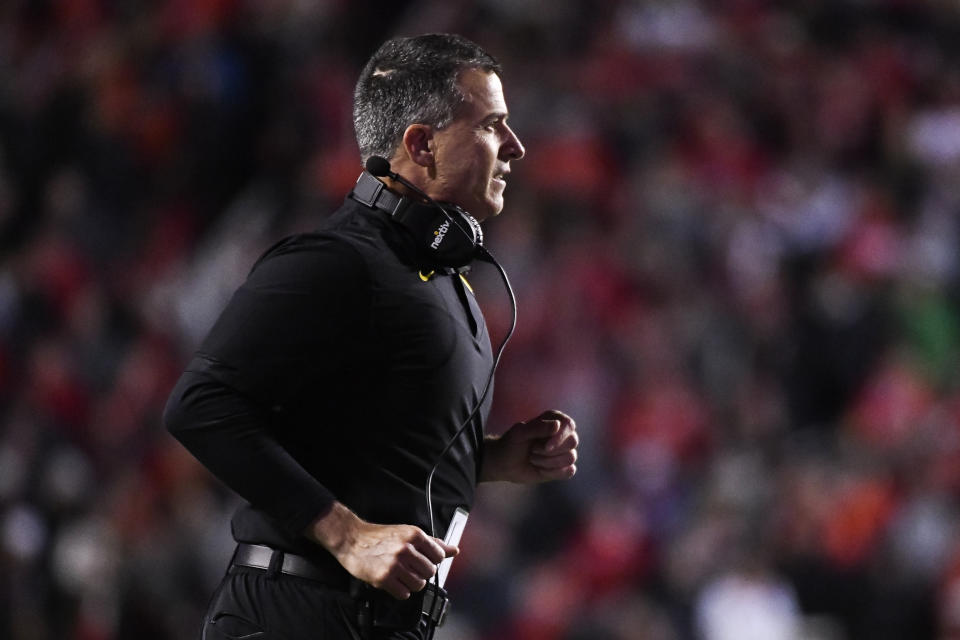 Oregon head coach Mario Cristobal runs to a player down on the field during the first half of an NCAA college football game against Utah, Saturday, Nov. 20, 2021, in Salt Lake City. (AP Photo/Alex Goodlett)