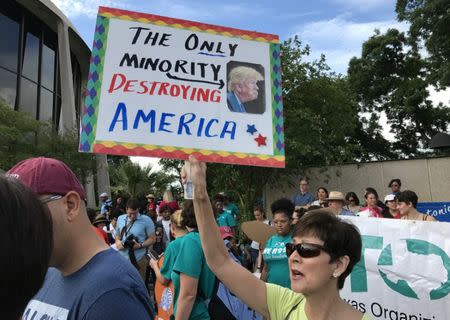 A protester against the Texas state law to punish "sanctuary cities" stands outside the U.S. Federal court in San Antonio, Texas, U.S., June 26, 2017. REUTERS/Jon Herskovitz