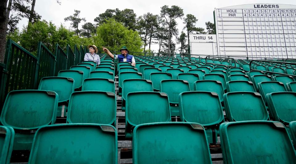 Kathy and Allen Hodges, of Palm Beach Gardens, Fla., watch the action during a sunny Masters practice round on Monday at Augusta National Golf Club.