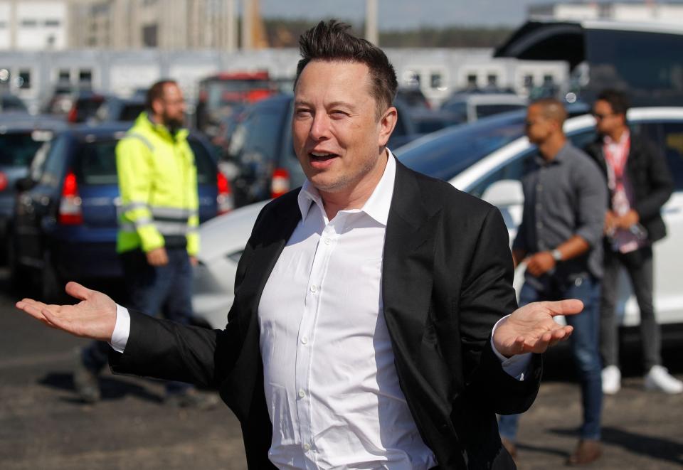 Tesla CEO Elon Musk gestures as he arrives to visit the construction site near Berlin.