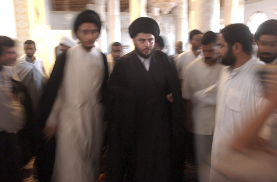 FILE - Muqtada al-Sadr is seen during prayers at the Al-Kufa Mosque Friday, July 18, 2003, in the holy city of Najaf, south of Baghdad, Iraq. Al-Sadr is a populist cleric, who emerged as a symbol of resistance against the U.S. occupation of Iraq after the 2003 invasion. (AP Photo/Wally Santana, File)