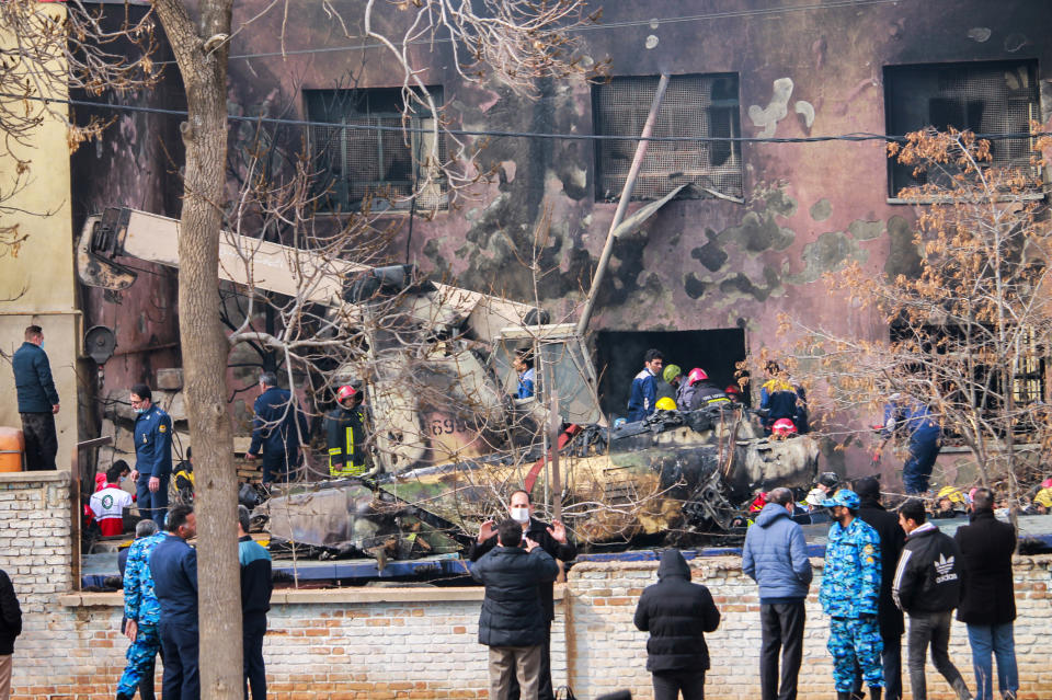 In this photo released by Tasnim News Agency, the wreckage of an Iranian F-5 fighter jet remains at the crash site in Tabriz, northwestern Iran, Monday, Feb. 21, 2022. Gen. Reza Yousefi, commander of the air base in Tabriz, said the crashed jet had been used for training and suffered a technical problem on its final flight that killed two pilots and a civilian. (Tasnim News agency via AP)