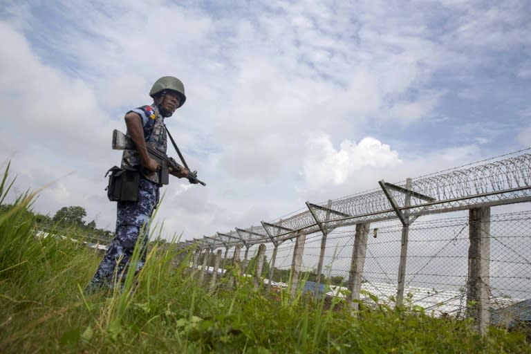 Myanmar border guards patrol the fence in the 'no man's land' between Myanmar and Bangladesh