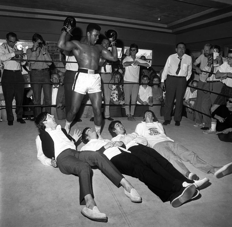 Cassius Clay poses with the Beatles