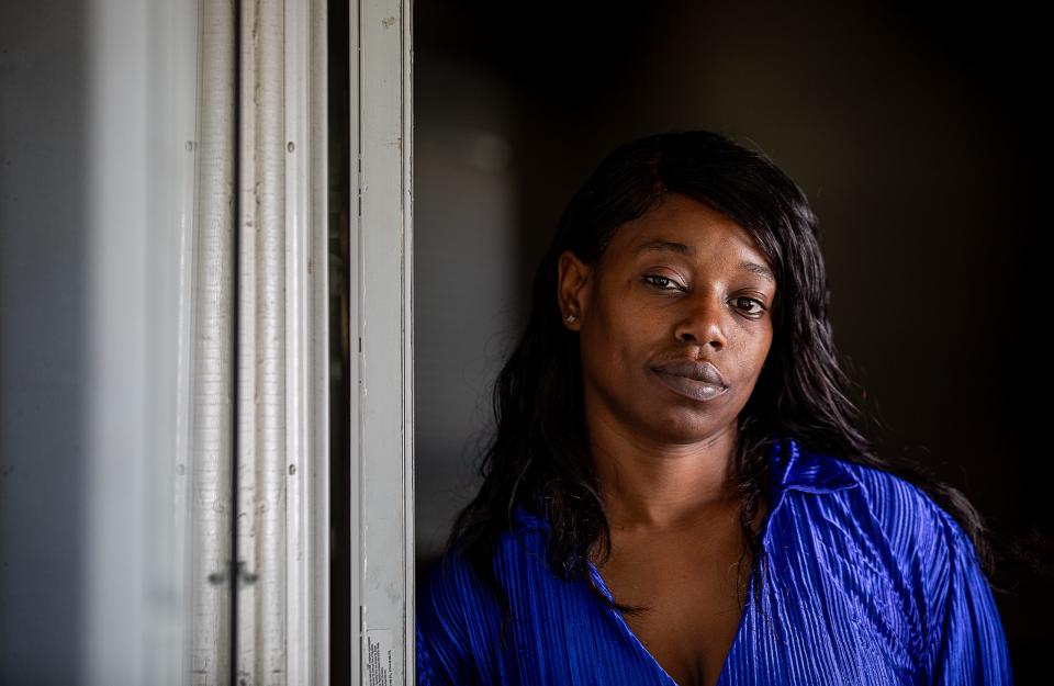 Kwmisha Adams stands in the doorway of her residence on Lindell Avenue in Louisville's Shawnee neighborhood. The house was built in the 1920s and has tested positive for lead paint on the front door frame, kitchen windowsill and other areas in the home. Adams is concerned about how exposure to lead could affect her five children and hopes to resolve her ongoing housing issues as soon as possible. Oct. 10, 2023