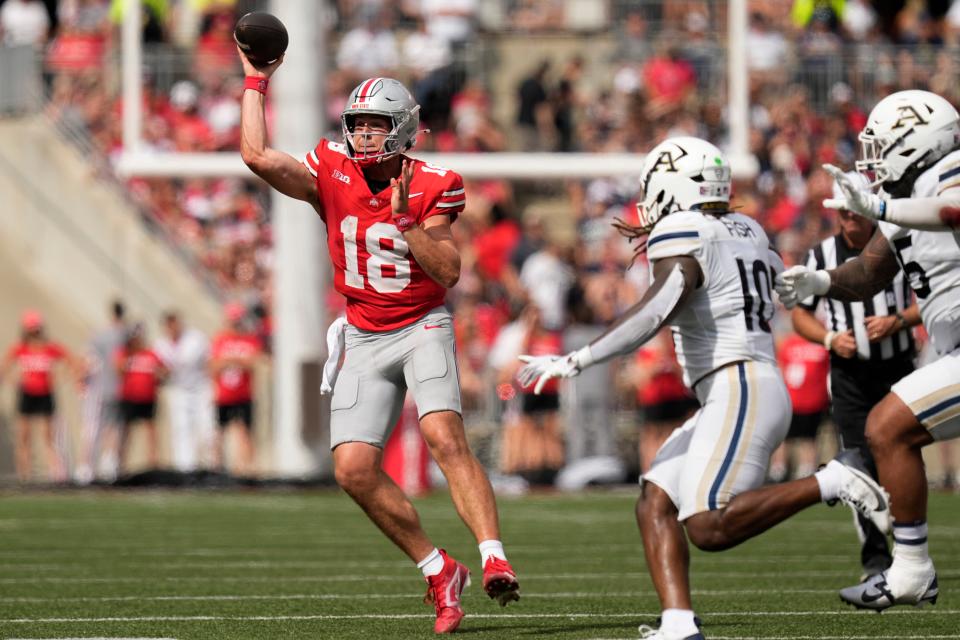 Aug 31, 2024; Columbus, OH, USA; Ohio State Buckeyes quarterback Will Howard (18) throws a pass over Akron Zips linebacker Antavious Fish (10) during the first half of the NCAA football game at Ohio Stadium.