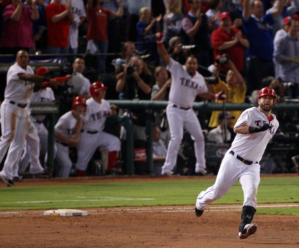 ARLINGTON, TX - OCTOBER 24: Mike Napoli #25 of the Texas Rangers rounds first base after hitting a two-run double in the eighth inning during Game Five of the MLB World Series against the St. Louis Cardinals at Rangers Ballpark in Arlington on October 24, 2011 in Arlington, Texas. (Photo by Doug Pensinger/Getty Images)