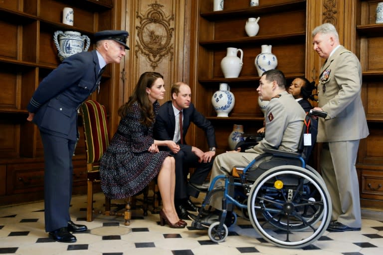 Britain's Prince William and the Duchess of Cambridge speak with wounded soldiers as they visit the military hospital at the Hotel des Invalides in Paris, on March 18, 2017