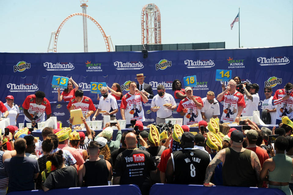 People competing in a hot dog eating contest