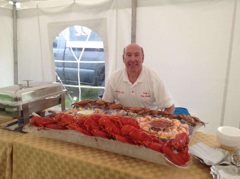 Sal Aulogia, owner of Sally's Fish Market in Newburgh, catering a private event with a spread of fresh lobster, shrimp and crab.