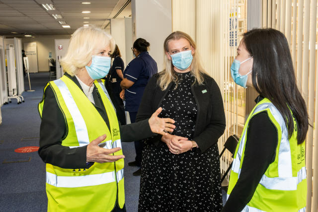 LONDON, ENGLAND - FEBRUARY 23: Camilla, Duchess of Cornwall, Royal Voluntary Service President, speaks to Liyann Ooi, a NHS Volunteer 
Responder Steward at Wembley Vaccination Centre on February 23, 2021 in London, England. (Photo by Philip Hartley-WPA Pool/Getty Images)