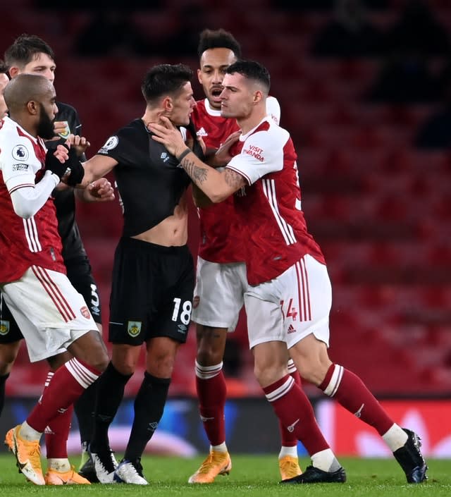 Granit Xhaka (right) was sent off against Burnley for grabbing Ashley Westwood round the throat