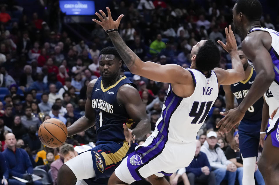 New Orleans Pelicans forward Zion Williamson (1) draws a fouls as he drives to the basket against Sacramento Kings forward Trey Lyles (41) in the first half of an NBA basketball game in New Orleans, Wednesday, Nov. 22, 2023. (AP Photo/Gerald Herbert)