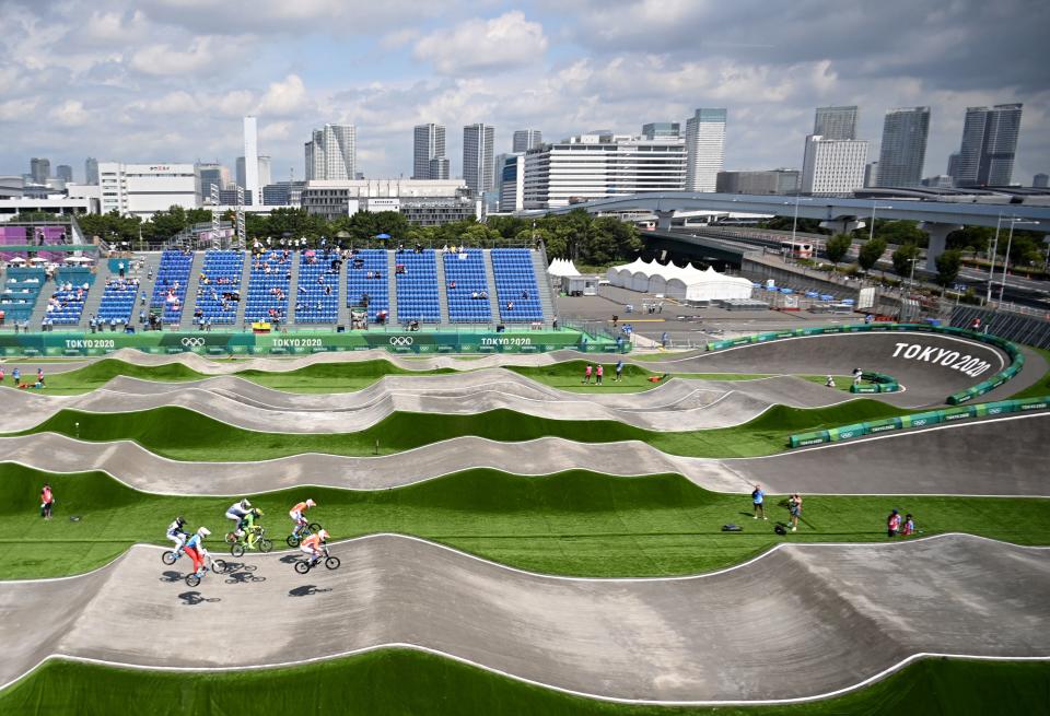 <p>TOPSHOT - Cyclists compete in the cycling BMX racing men's quarter-finals run at the Ariake Urban Sports Park during the Tokyo 2020 Olympic Games in Tokyo on July 29, 2021. (Photo by Lionel BONAVENTURE / AFP) (Photo by LIONEL BONAVENTURE/AFP via Getty Images)</p> 