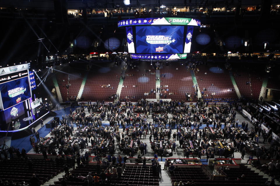 Teams, owners, coaches and other personnel get ready for the start of the second round of the NHL draft at Rogers Arena in Vancouver, British Columbia, Saturday, June 22, 2019. (Chad Hipolito/The Canadian Press via AP)