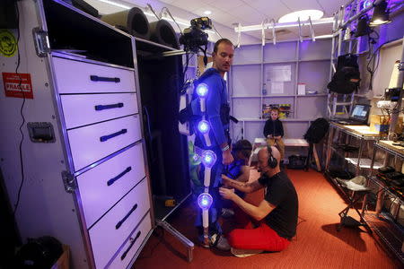 Ugo Dumont, a volunteer for the Genworth R70i Aging Experience demonstration, is fitted for the R70i Age Suit before a demonstration at the Liberty Science Center in Jersey City, New Jersey, April 5, 2016. REUTERS/Shannon Stapleton