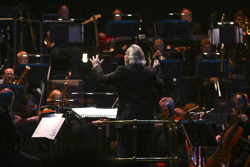 LONDON, ENGLAND - OCTOBER 04: Composer Nicholas Dodd performs on stage accompanied by The Royal Philharmonic Concert Orchestra during The Sound of 007 in concert at The Royal Albert Hall on October 04, 2022 in London, England. (Photo by Jeff Spicer/Getty Images for EON Productions & Prime Video)