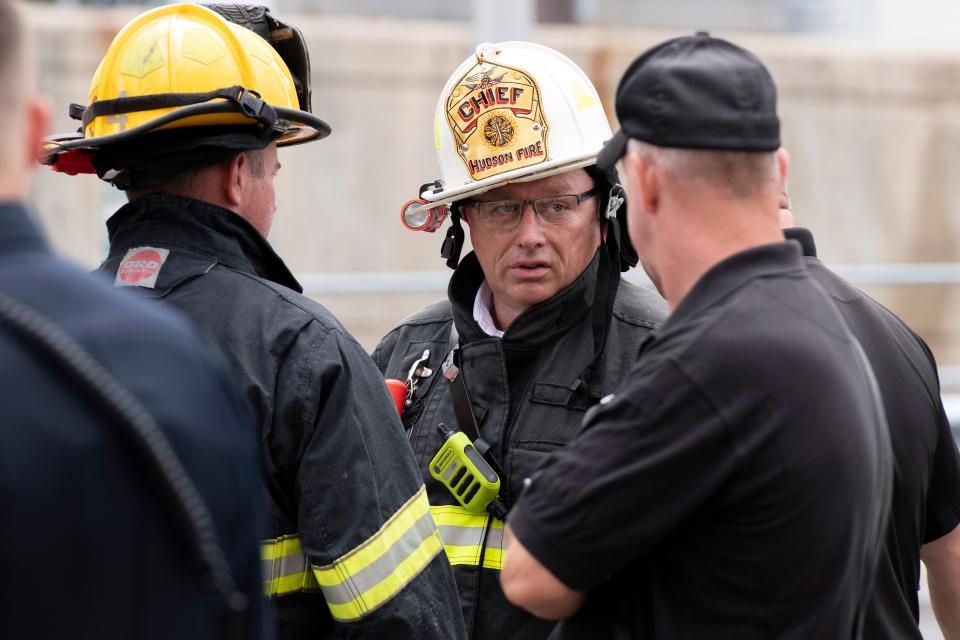 Hudson Fire Chief Bryan Johannes (center) talks with a fire investigator, after Hudson firefighters brought a fire at Hudson Dental Care at 241 Main Street in Hudson under control, Aug. 23, 2021.xx