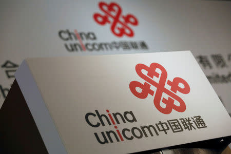 FILE PHOTO: Company logos of China Unicom are displayed at a news conference during the company's announcement of its annual results in Hong Kong, China March 16, 2016. REUTERS/Bobby Yip/File Photo