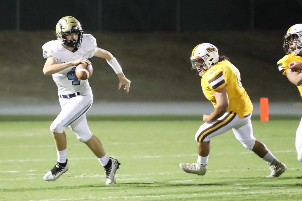 Monache quarterback Emmett Focke (4) scrambles against Golden West in an East Yosemite League high school football game at Visalia Community Stadium in Visalia, Calif., Friday, Sept. 30, 2022.