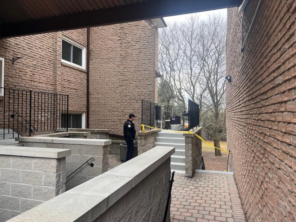 Toronto police outside a townhouse where a woman was found dead early Thursday. (Darek Zdzienicki/CBC - image credit)