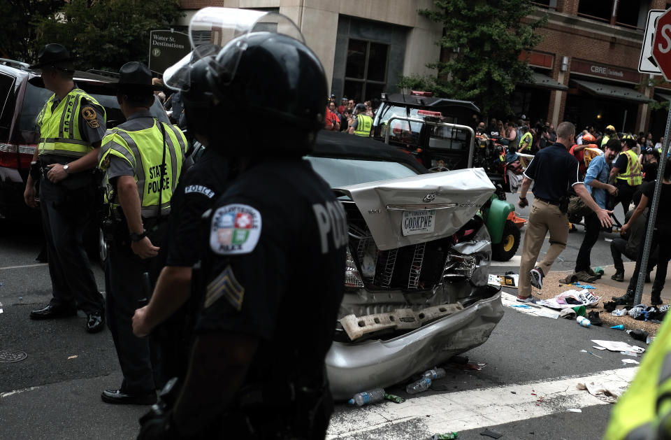 <p>First responders stand by a car that was struck when a car drove through a group of counter protesters at the “Unite the Right” rally Charlottesville, Va., Aug. 12, 2017. (Photo: Justin Ide/Reuters) </p>