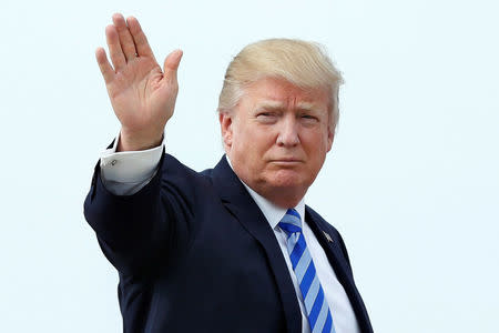 U.S. President Donald Trump waves as he boards Air Force One at Joint Base Andrews outside Washington, U.S., before traveling to Palm Beach, Florida for the Good Friday holiday/Easter weekend, April 13, 2017. REUTERS/Yuri Gripas