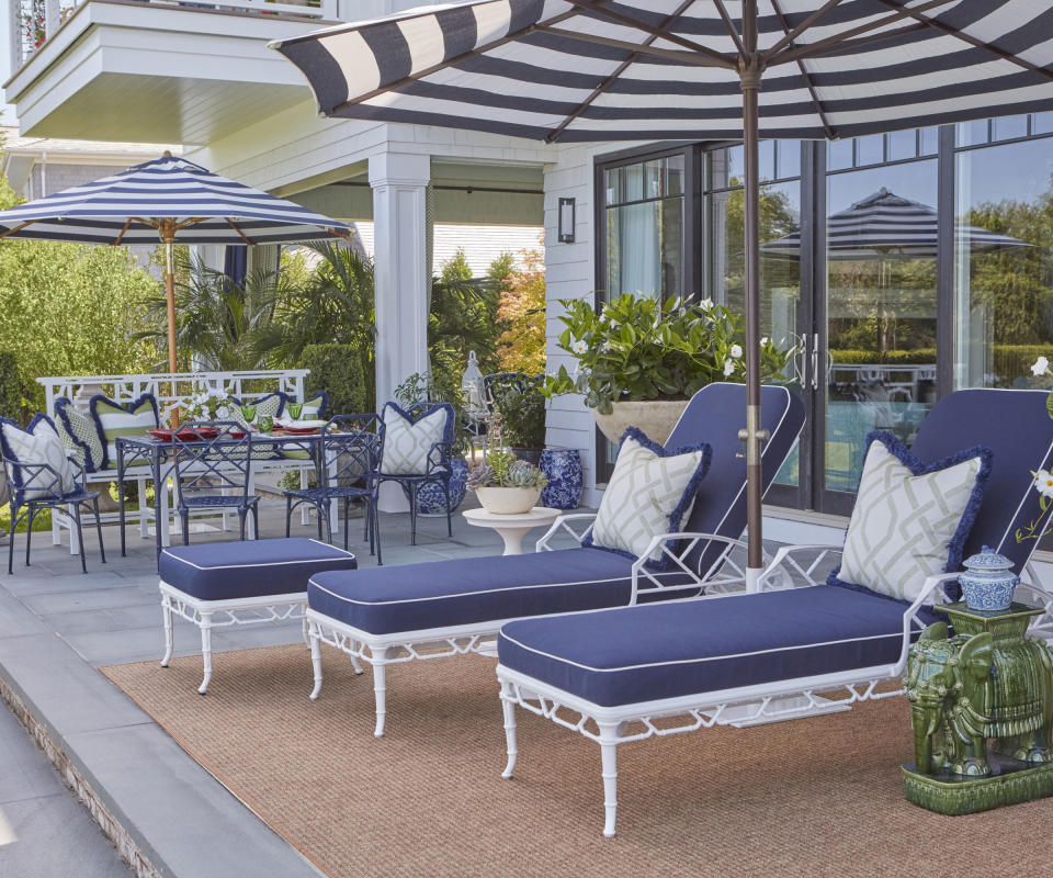 patio with loungers and umbrella