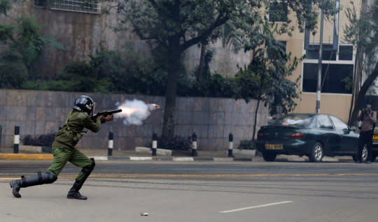 <p>A riot police officer fires a tear gas canister to disperse supporters of Kenya’s opposition Coalition for Reforms and Democracy during a protest ahead of next year’s election in Nairobi, Kenya, on May 23, 2016. (Thomas Mukoya/Reuters) </p>