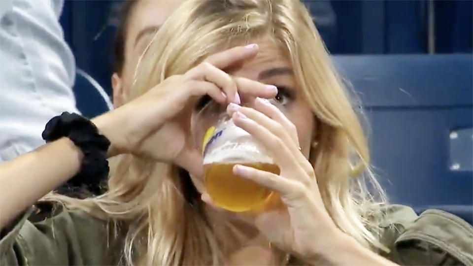 The US Open fan, pictured here repeating her feat by downing a second beer.