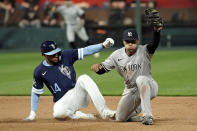 New York Yankees shortstop Isiah Kiner-Falefa forces Kansas City Royals' Edward Olivares (14) out at second for a double play hit into by Andrew Benintendi during the seventh inning of a baseball game Saturday, April 30, 2022, in Kansas City, Mo. (AP Photo/Charlie Riedel)