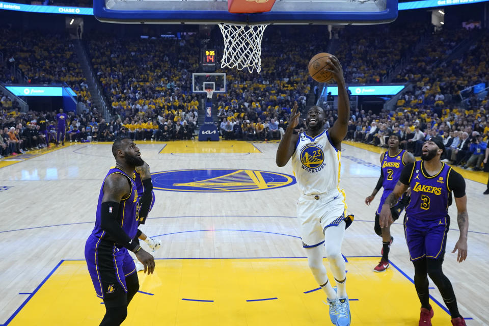 Golden State Warriors forward Draymond Green (23) goes up for a shot against Los Angeles Lakers forward LeBron James, left, during the first half of Game 2 of an NBA basketball Western Conference semifinal game, Thursday, May 4, 2023, in San Francisco. (AP Photo/Godofredo A. Vásquez)