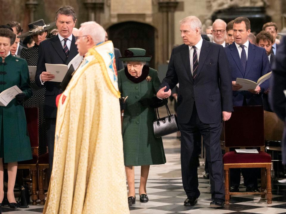 Queen Elizabeth and Prince Andrew walk into Westminster Abbey arm in arm.