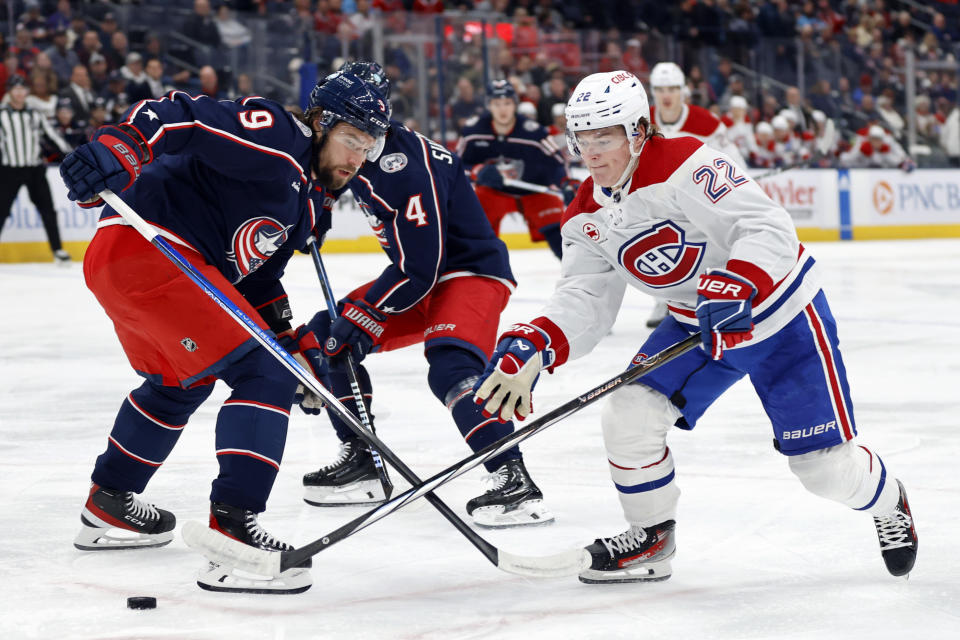 Montreal Canadiens forward Cole Caufield, right, reaches for the puck in front of Columbus Blue Jackets defenseman Ivan Provorov during the first period of an NHL hockey game in Columbus, Ohio, Wednesday, Nov. 29, 2023. (AP Photo/Paul Vernon)