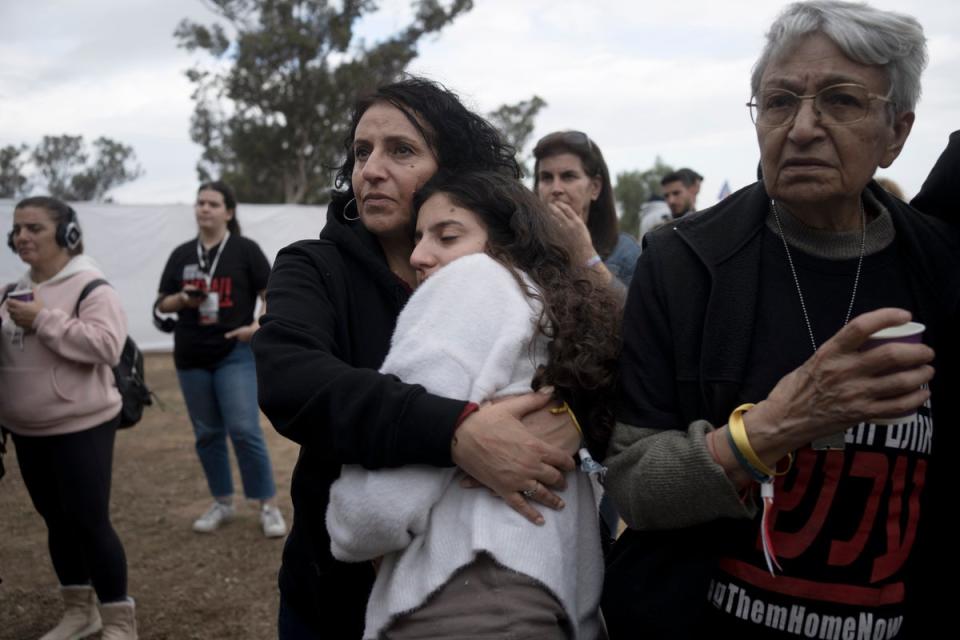 Relatives of hostages listen to a press conference at the site in Re'im, southern Israel (AP)