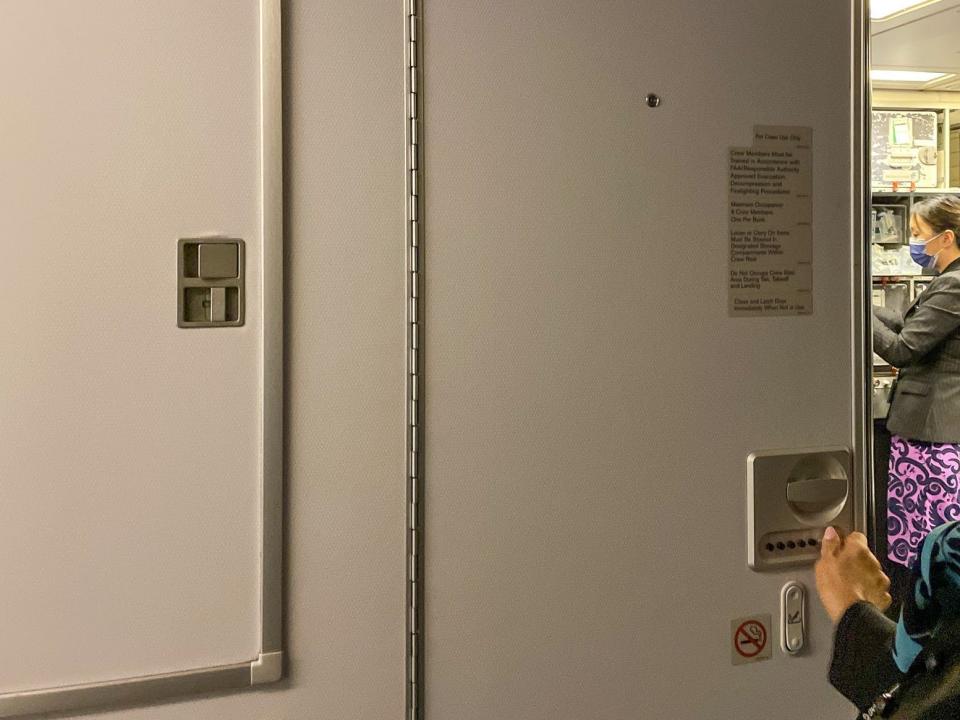Sarita Rami unlocks the door to the secret plane bedrooms for flight attendants.
