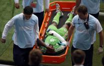 Nigeria's Michael Babatunde is carried off after breaking his wrist during their Group F match against Argentina. After the match, the Nigerian coach stated that Babatunde was being treated but would need at least three weeks to recover. (Marko Djurica/Reuters)