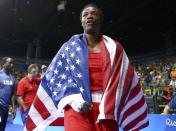 2016 Rio Olympics - Boxing - Final - Women's Middle (75kg) Final Bout 270 - Riocentro - Pavilion 6 - Rio de Janeiro, Brazil - 21/08/2016. Claressa Shields (USA) of USA wears her national flag as she celebrates after winning her bout. REUTERS/Peter Cziborra