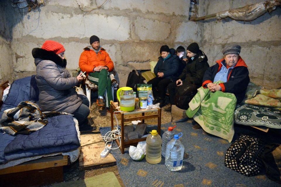 Pictured here, civilians hiding in the basement of their apartment building in the Ukrainian city of Kharkiv. 